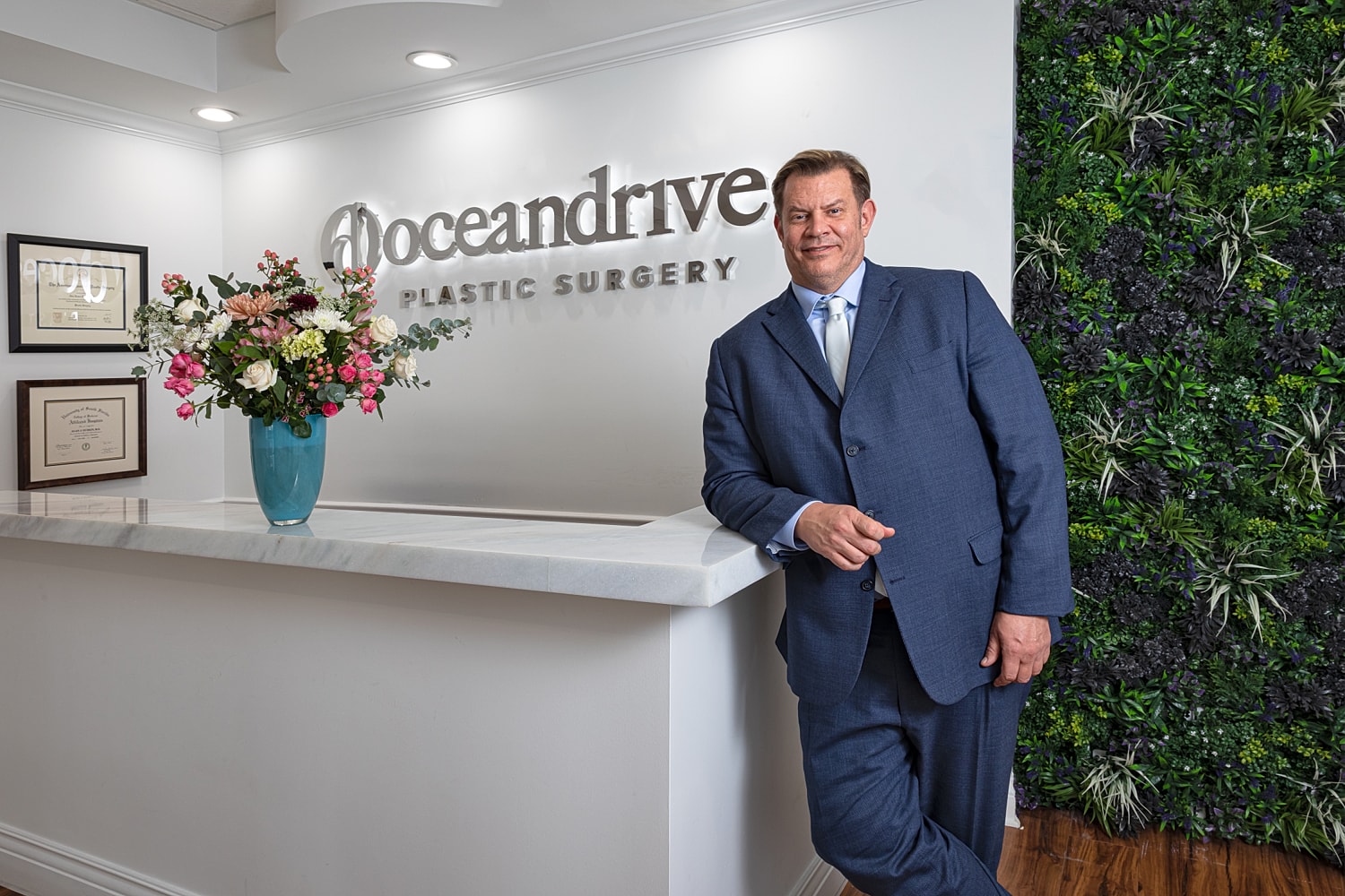 Plastic surgery office with floral arrangements and Dr. Alan Durkin