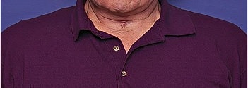 Man in purple polo shirt against blue background.