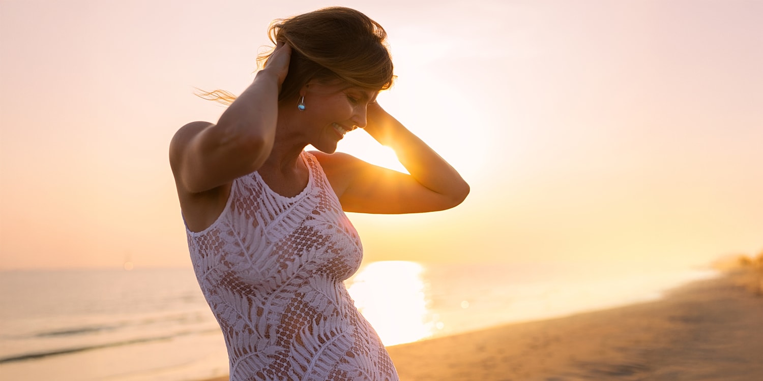 Woman enjoying sunset on the beach.