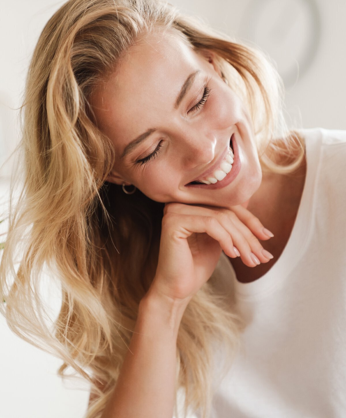 Blonde Vero beach female model smiling with white top