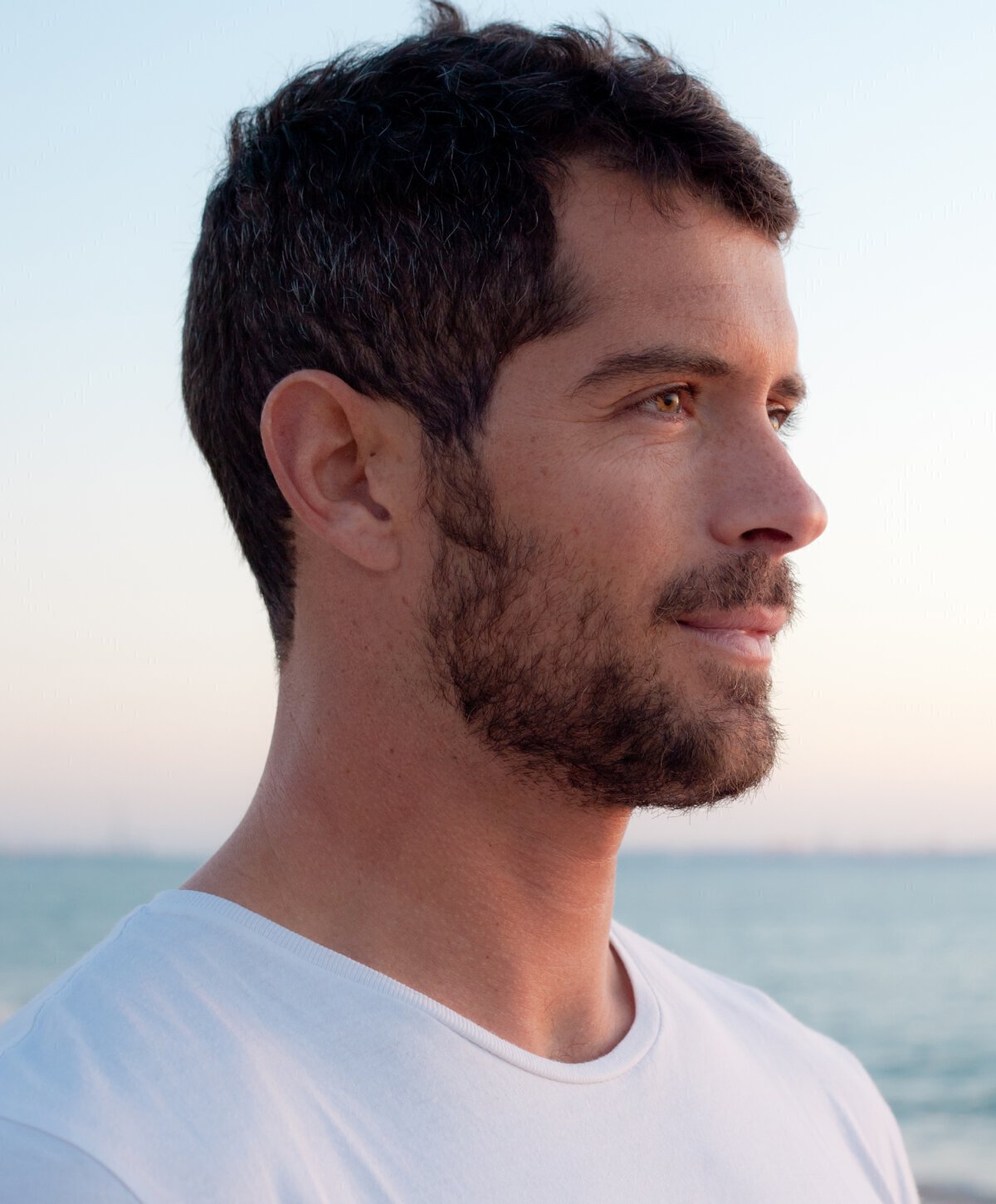 Man's face with white shirt smiling