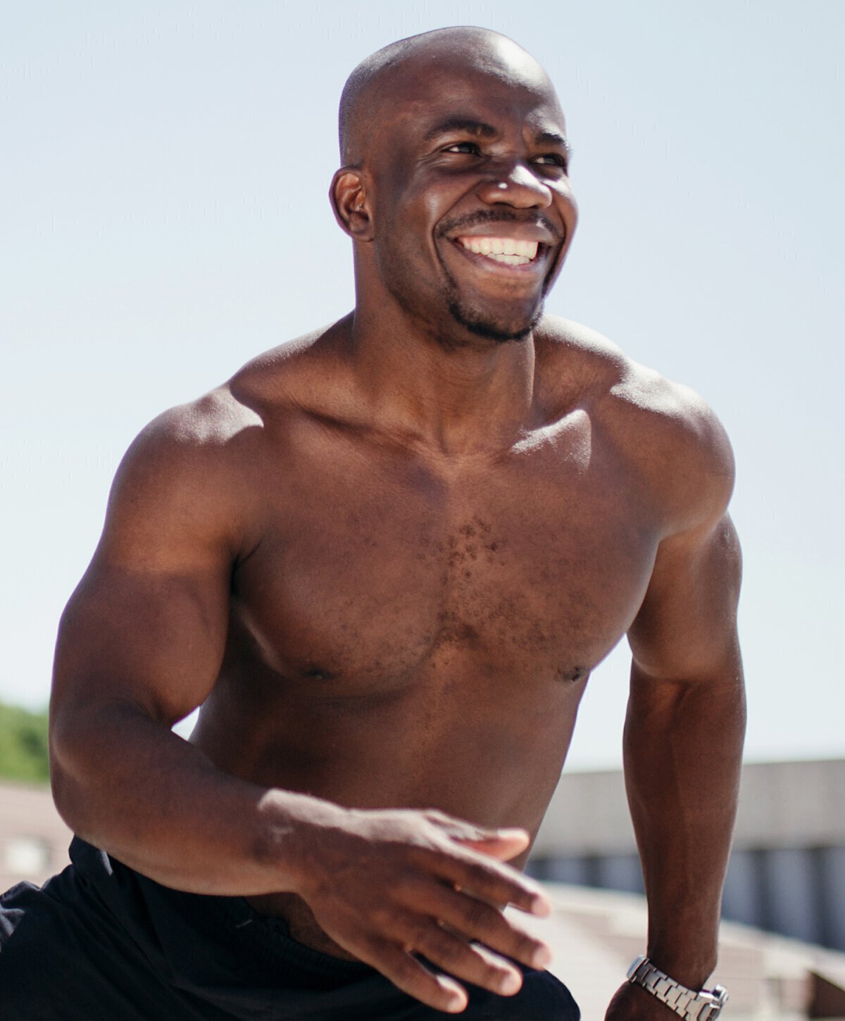 Man smiling shirtless on Vero Beach