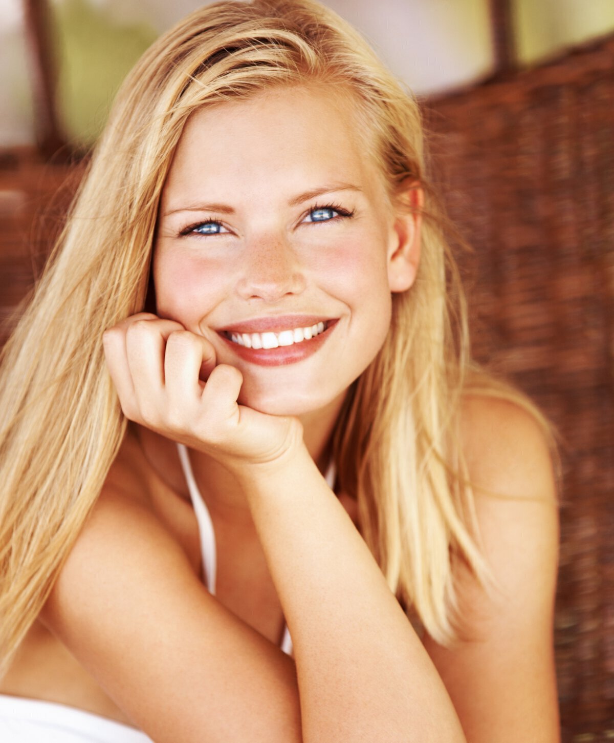 Blonde woman smiling sitting down