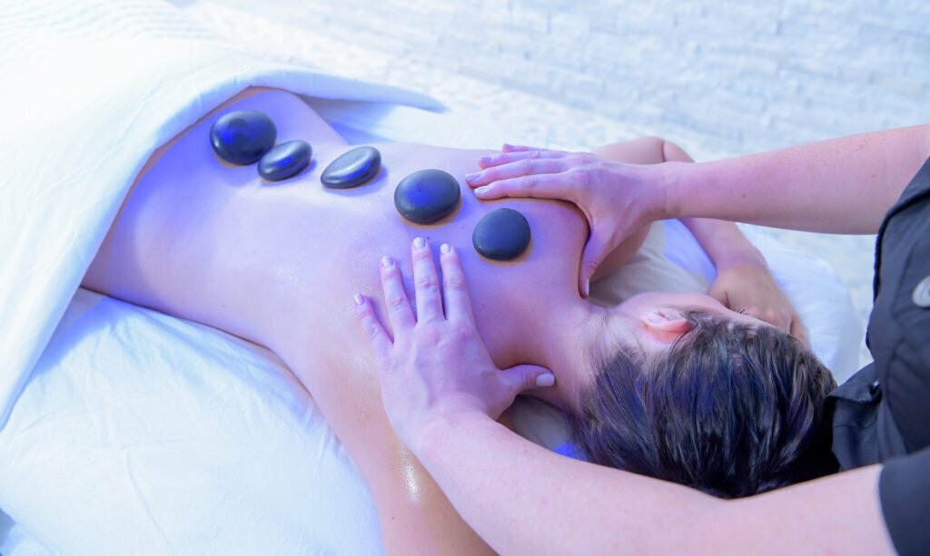 Customer receiving massage with stones