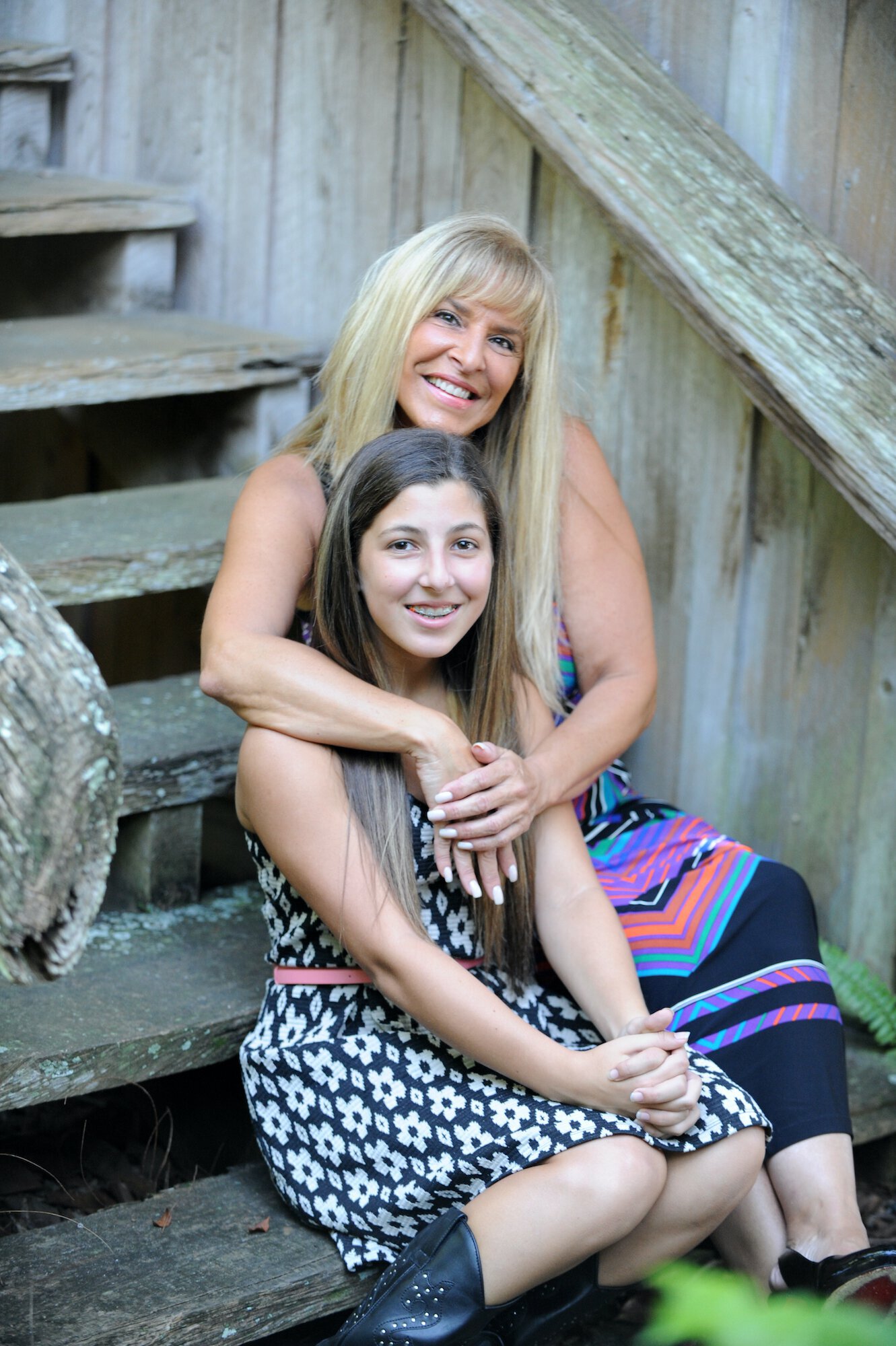 Beautiful facelift patient hugging her daughter