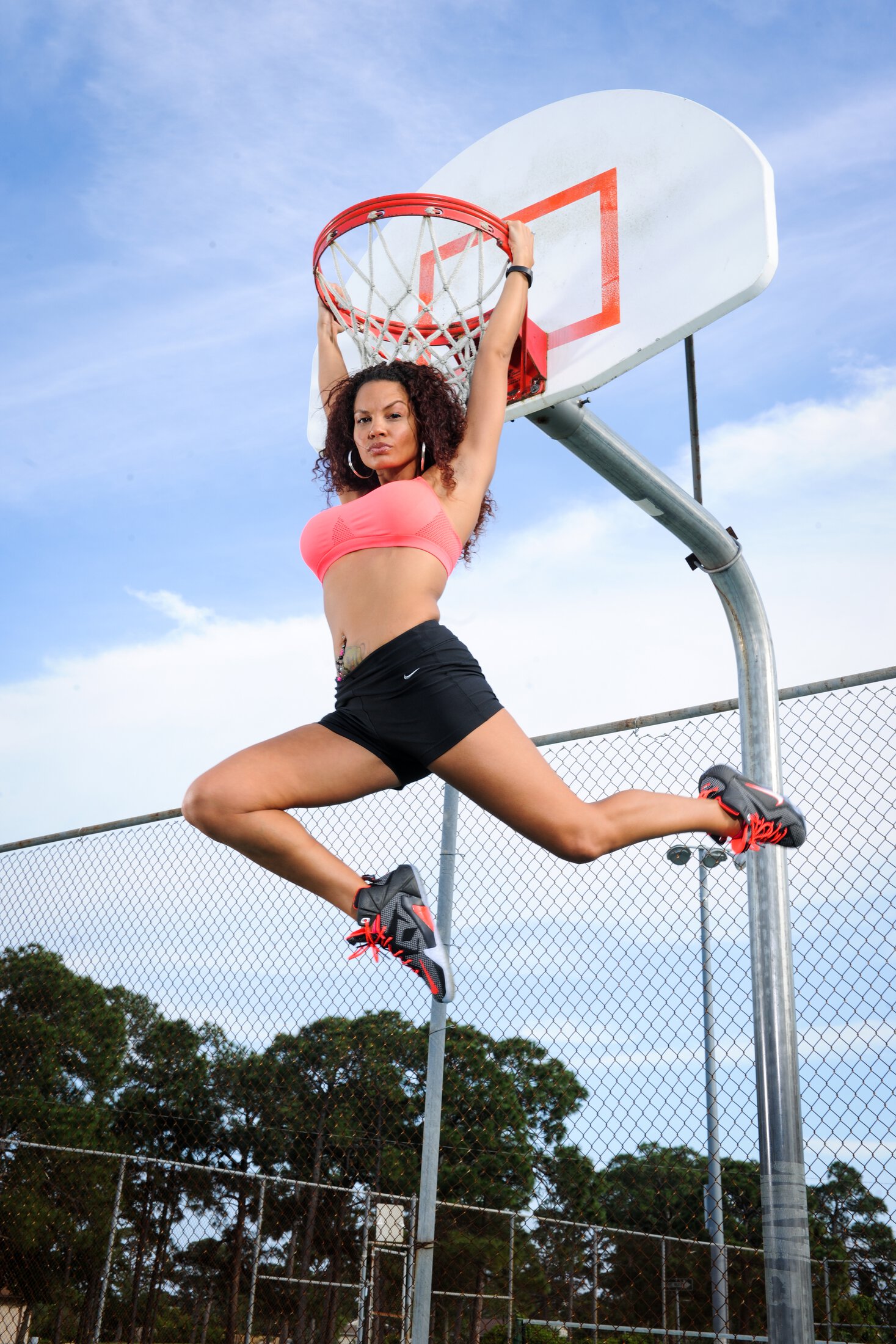 Vero Beach Breast Enhancement patient hanging from a basketball hoop