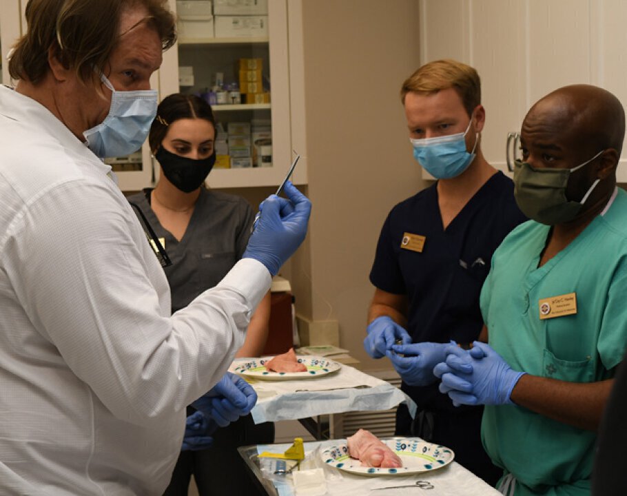 Vero Beach Plastic Surgeon expert Dr. Alan Durkin training others on suture procedure